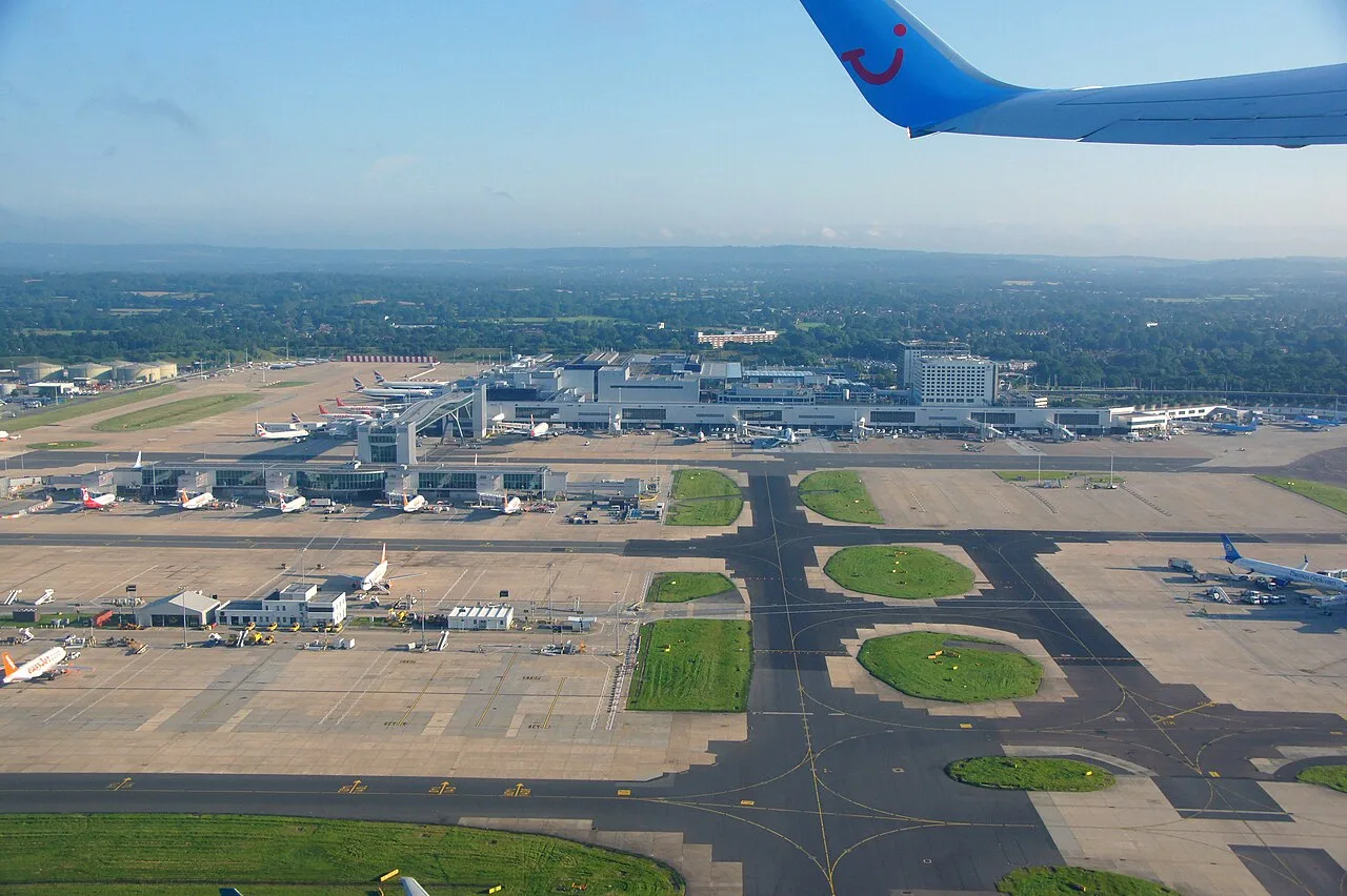 Aerial overview photograph of London Gatwick Airport (EGKK/LGW), showing the terminal complex, apron and single runway from above.